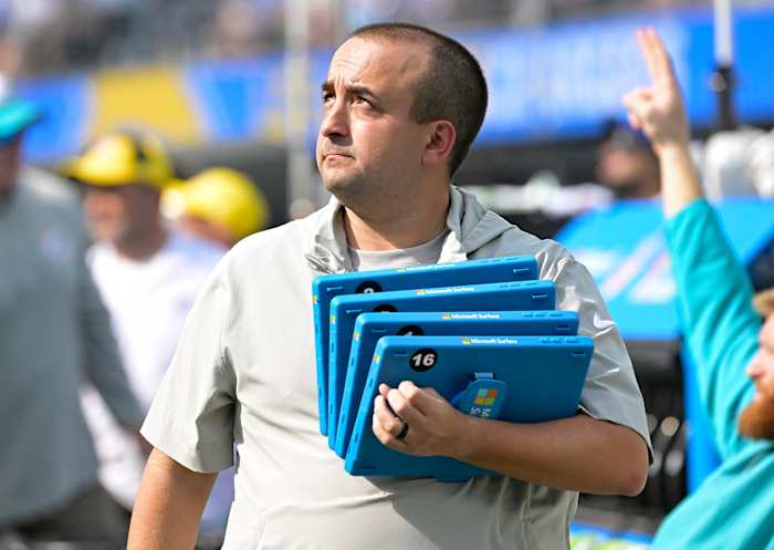 Dolphins football systems specialist Patrick Oliver holds Microsoft Surface tablets on the sideline.